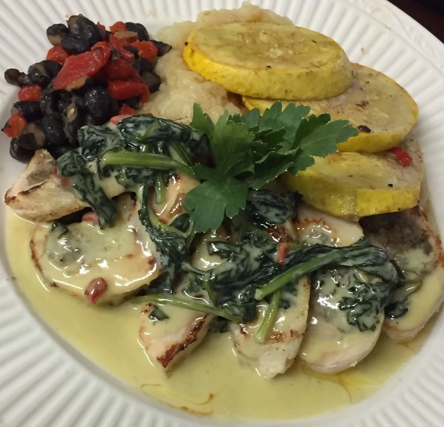 Plated chicken entrée with vegetables from Sherm's Catering