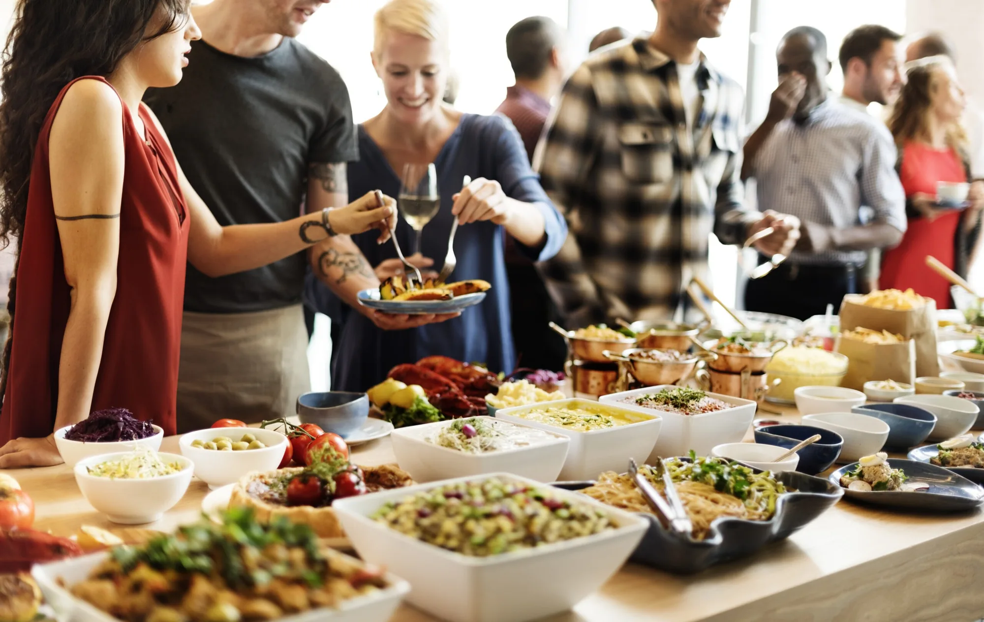 Office staff serving themselves from a Sherm's Catering corporate lunch buffet in the Wilmington, DE area