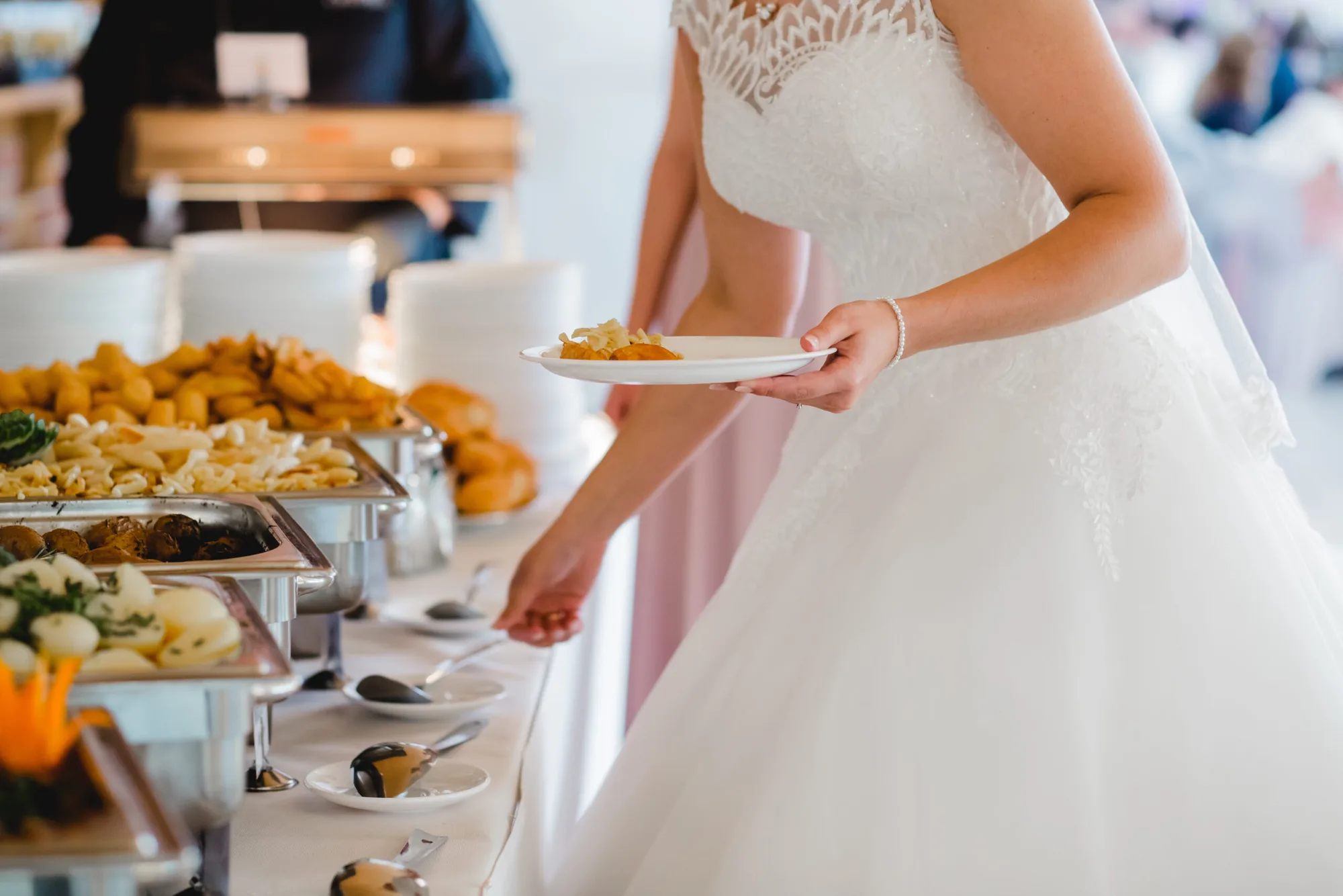 Bride serving herself at a Sherm's Catering wedding buffet in Delaware